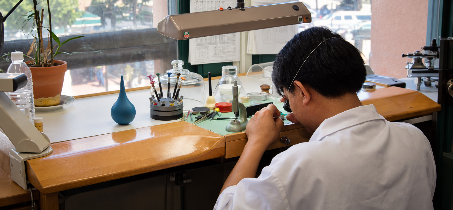 Watchmaker carefully working at a repair bench